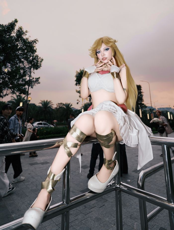 Person in elaborate fantasy cosplay poses outdoors at twilight.